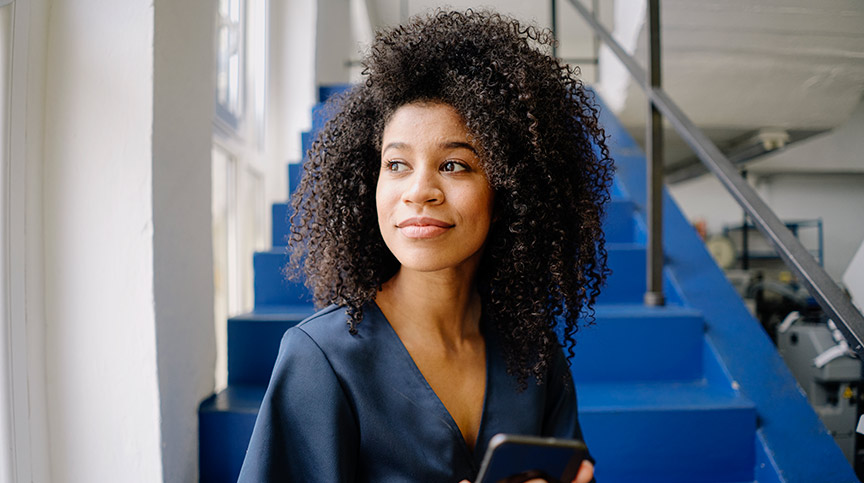 5 Proven Ways for photo of woman smiling as she consider ways organizations are Attracting, Retaining, and Developing Women Leaders