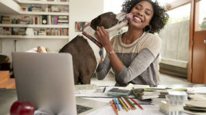 Photo of woman with dog smiling contemplating 8 resilient leadership resilience practices