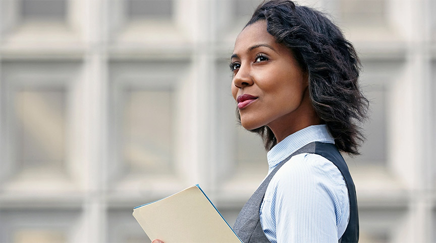 Portrait of young business woman holding paper work, looking away, side view, thinking about why leadership development is important