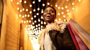 Woman smiling as she learns how to Maximize Joy and 4 Savoring Strategies for the Holidays and Beyond