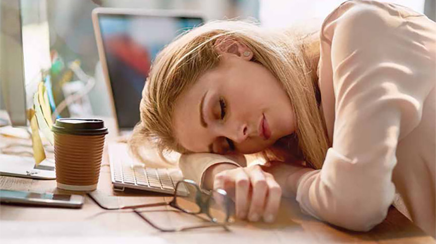 woman asleep at her desk, tired at work