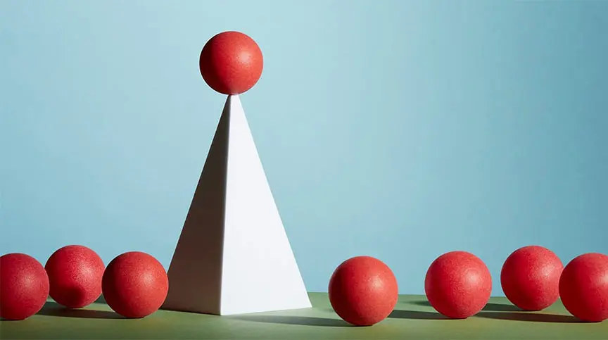 vector image of one red sphere on top of pyramid above other red spheres representing concept of how to achieve systemic change starting at the top