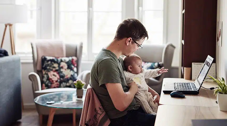 father with child working showing how flexible work arrangements can improve employee retention