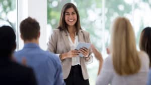 image of woman in the workplace delivering presentation and overcoming the gender gap in the workplace