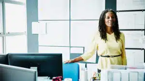 woman standing in her office considering CCL's leadership training portfolio