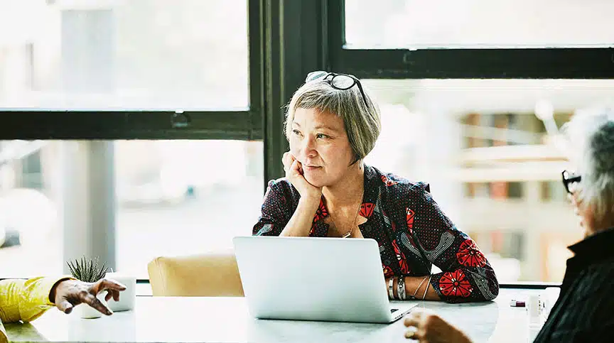 Woman listening to leadership advice on active listening while on computer