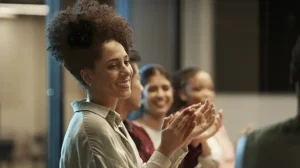 A team of leaders smiles as they experience belonging in the workplace