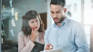 Two people shown discussing the challenges of leadership through uncertainty and leading in disruptive times