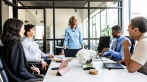 A photo of people meeting to drive results in their organization.