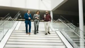 Business colleagues walking down stairs while talking, discussing the importance of wisdom in leadership